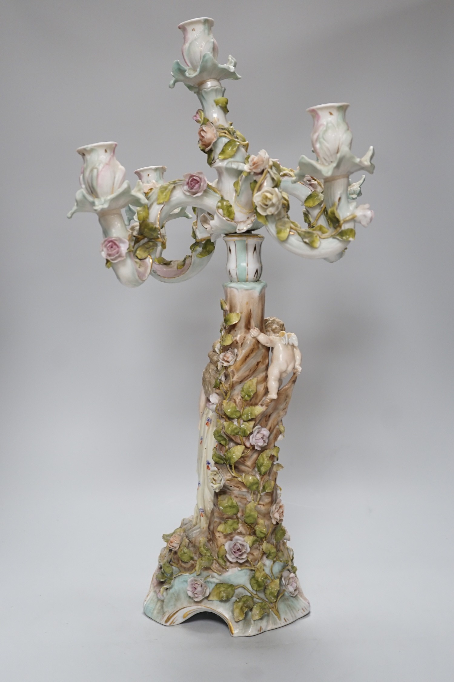 A Sitzendorf-style floral encrusted 4 branch candelabra, 57cms high